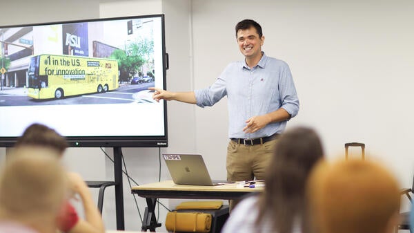 ASU Professor Visar Berisha gives a presentation to participants in a classroom.