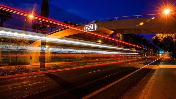 A timelapse photo of the ASU Tempe campus pedestrian bridge at night.