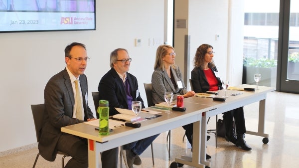 ASU policy experts sit lined up at a table during a discussion.