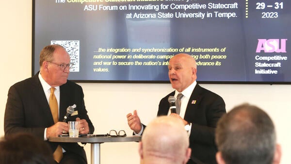 Speakers standing in front of an audience at ASU Form on Innovating for Competitive Statecraft.