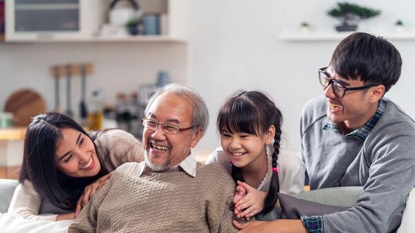 A family sitting together smiling.