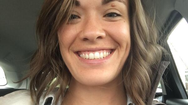 Graduating ASU student Alisa Bozich smiling at her camera from inside a car.