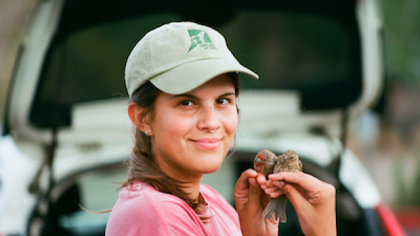 Allyson Shaw holds two house finches