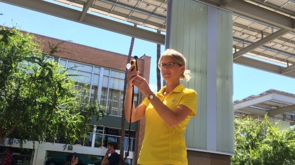 Ariane Middel in front of Memorial Union with meteorological instrument