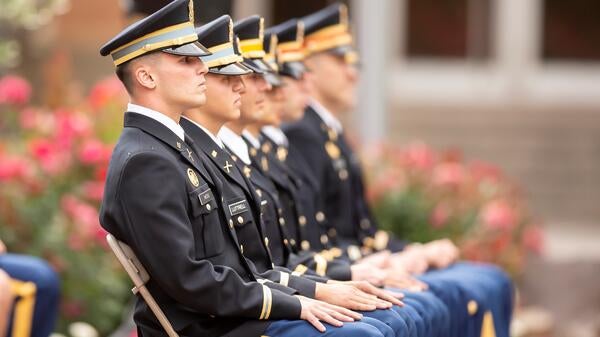 ASU Army ROTC graduating cadets seated in a row, wearing ceremonial regalia at the 2019 Spring Commissioning Ceremony.