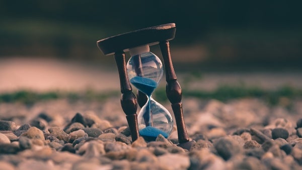 A photo of a hourglass on a pile of stones