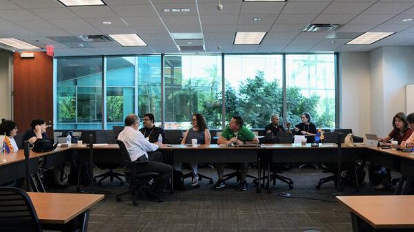 People sitting at a large conference table.