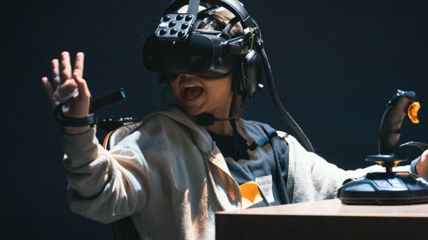 Student wearing a VR headset while looking at their hand.