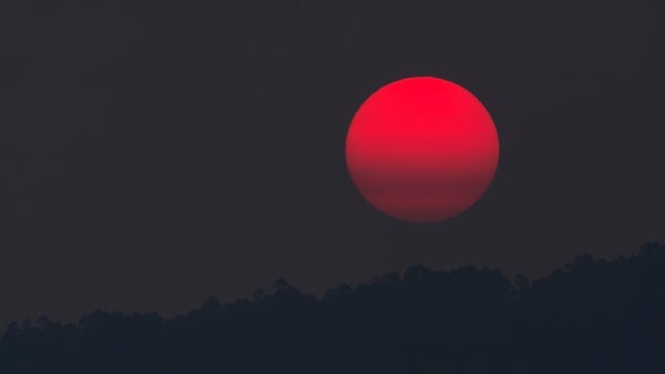 Blood moon over a mountain at night