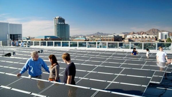 professor with students viewing solar panels on ASU rooftop