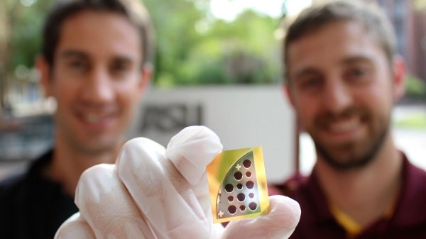 Mathieu Boccard (left) and Jacob Becker (right) pose with a 20 percent CdTe solar cell developed in tandem by Yong-Hang Zhang's and Zachary Holman's laboratories