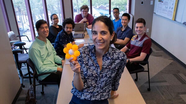 Andrea Richa heads a room of her student researchers. 