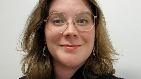 Portrait of graduating ASU student Clarissa Rubio Goldsmith, who is wearing glasses and a black, high-necked shirt.