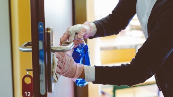 Woman cleaning door handle