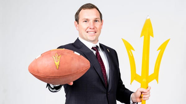 Portrait of coach with football and pitchfork