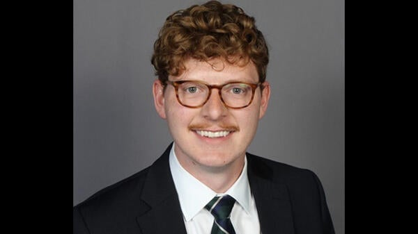 man with glasses and mustache in a suit