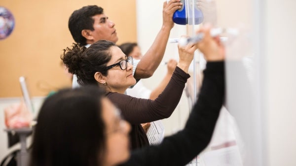 students writing on white board