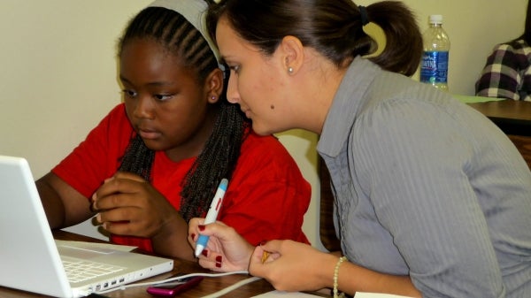 COMPUGIRLS mentor-teacher and student working at a computer