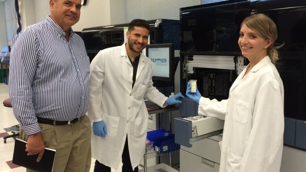 ASU alumnus Dan Kolk with two lab assistants at Hologic 