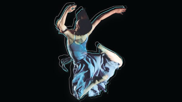 dancer in blue dress leaps into the air