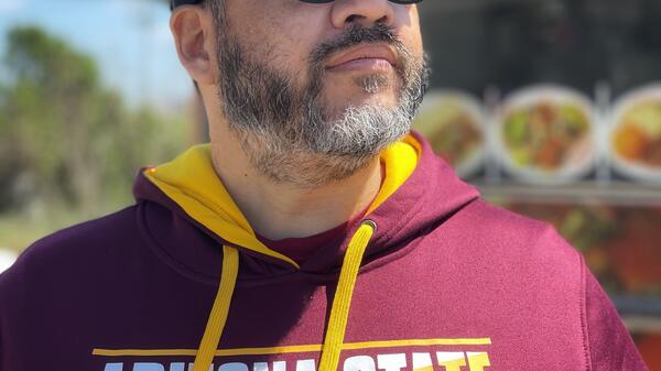 David Lew proudly shows off his ASU gear.