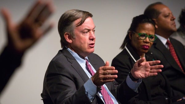 People at a public dialogue, using hand gestures.