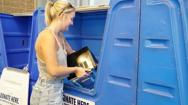 Photo of ASU student recycling item during Ditch the Dumpster