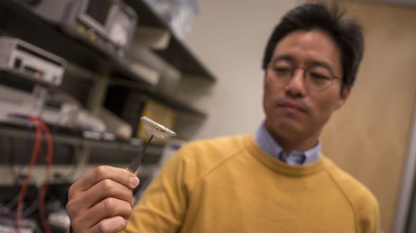 Junseok Chae holds a prototype of a wireless, fully passive neural recorder.