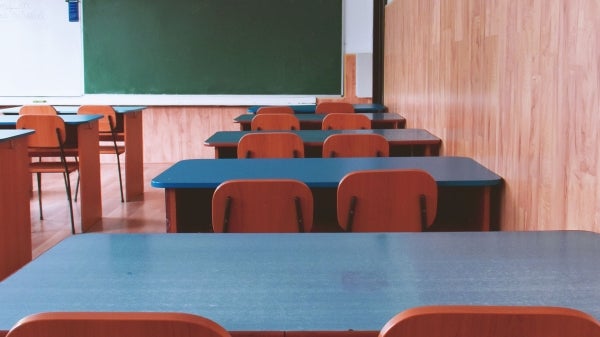 rows of empty desks in classroom