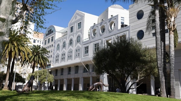 Exterior photo of a white building featuring many shapes of windows and trompe l'oeil architectural details