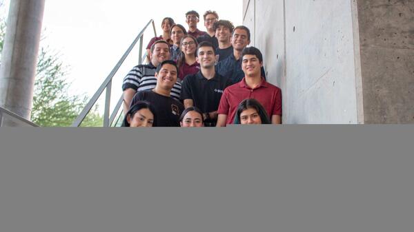 Students of the ASU chapter of the Society of Hispanic Professional Engineers pose for a group photo on a staircase.