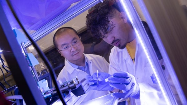 Ira A. Fulton Schools of Engineering Assistant Professor Kenan Song and mechanical systems engineering major Nathan Fonseca work on research in the lab.