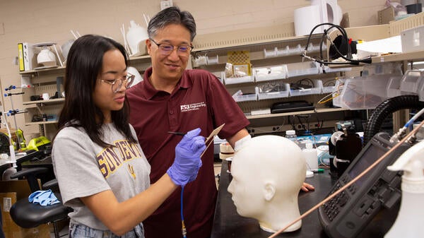 A student and faculty member work together in the lab.