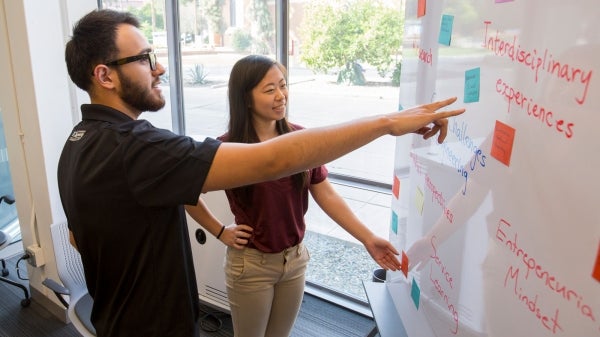 Students work on a whiteboard.