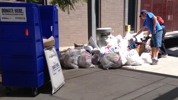 Photo of Goodwill staff inspecting waste during Ditch the Dumpster donation event