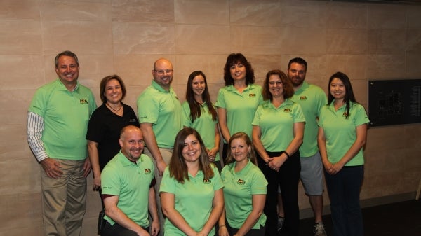 group of people in green polos