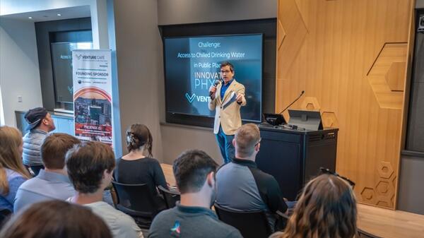 ASU alum Michael Hammett speaking to an audience in an auditorium.