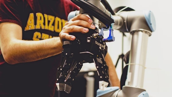 person holding a robotic hand