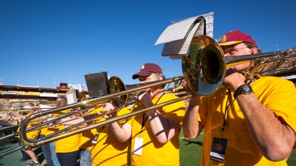 Alumni perform with the Marching Band at Homecoming