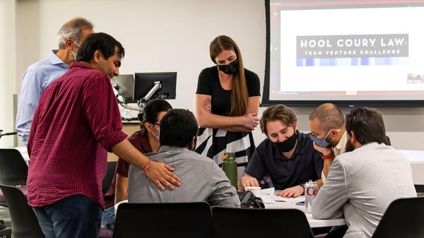 A group of student entrepreneurs work together at the Hool Coury Law Tech Venture Showcase.