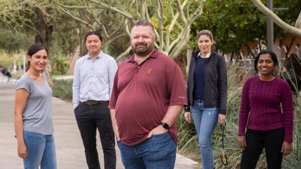 five people standing outside