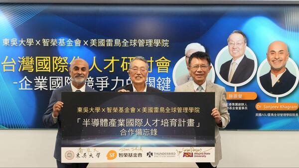 Three men holding a banner with Mandarin writing on it.