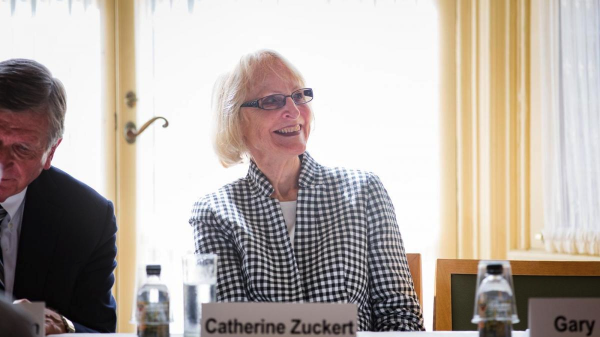 woman seated at table smiling