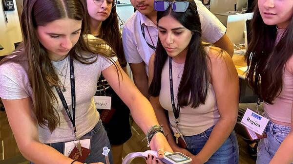 High school students practice intubation on a manikin at ASU's Summer Health Institute.