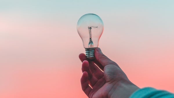 photo of hand holding lightbulb