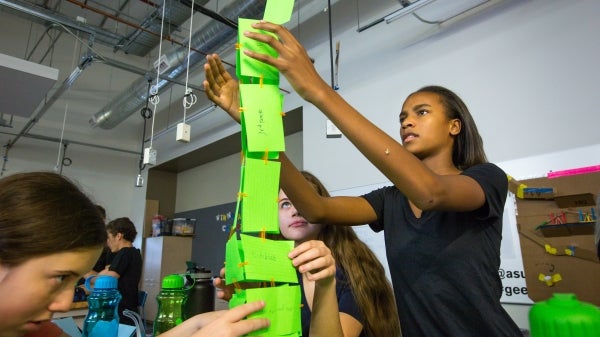 student building tower at summer camp