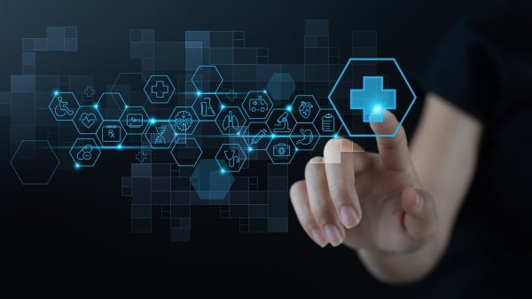 Graphic illustration of health care data, represented by various digital icons. A human hand reaches toward one of the icons to select it.