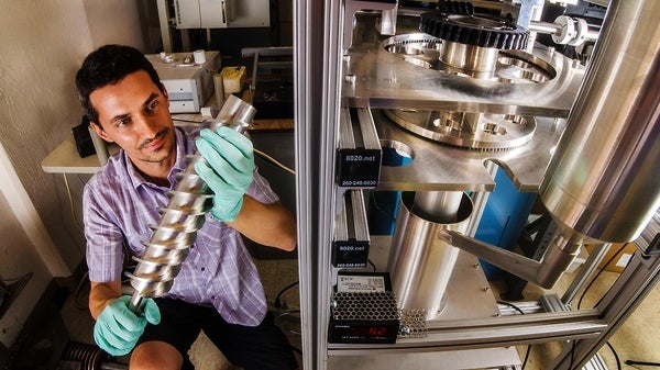 This is a photo of a man holding a piece of equipment. Ivan Ermanoski says he came to ASU because of its commitment to improve the world’s future and because of ASU’s multidisciplinary research environment. He says he values working with people outside of