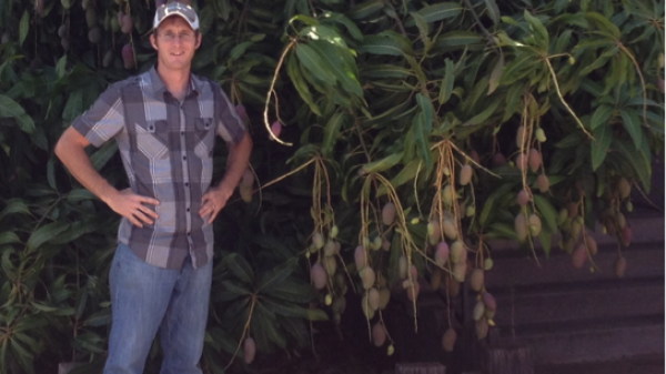 man standing next to tree