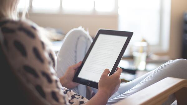 woman reading a Kindle